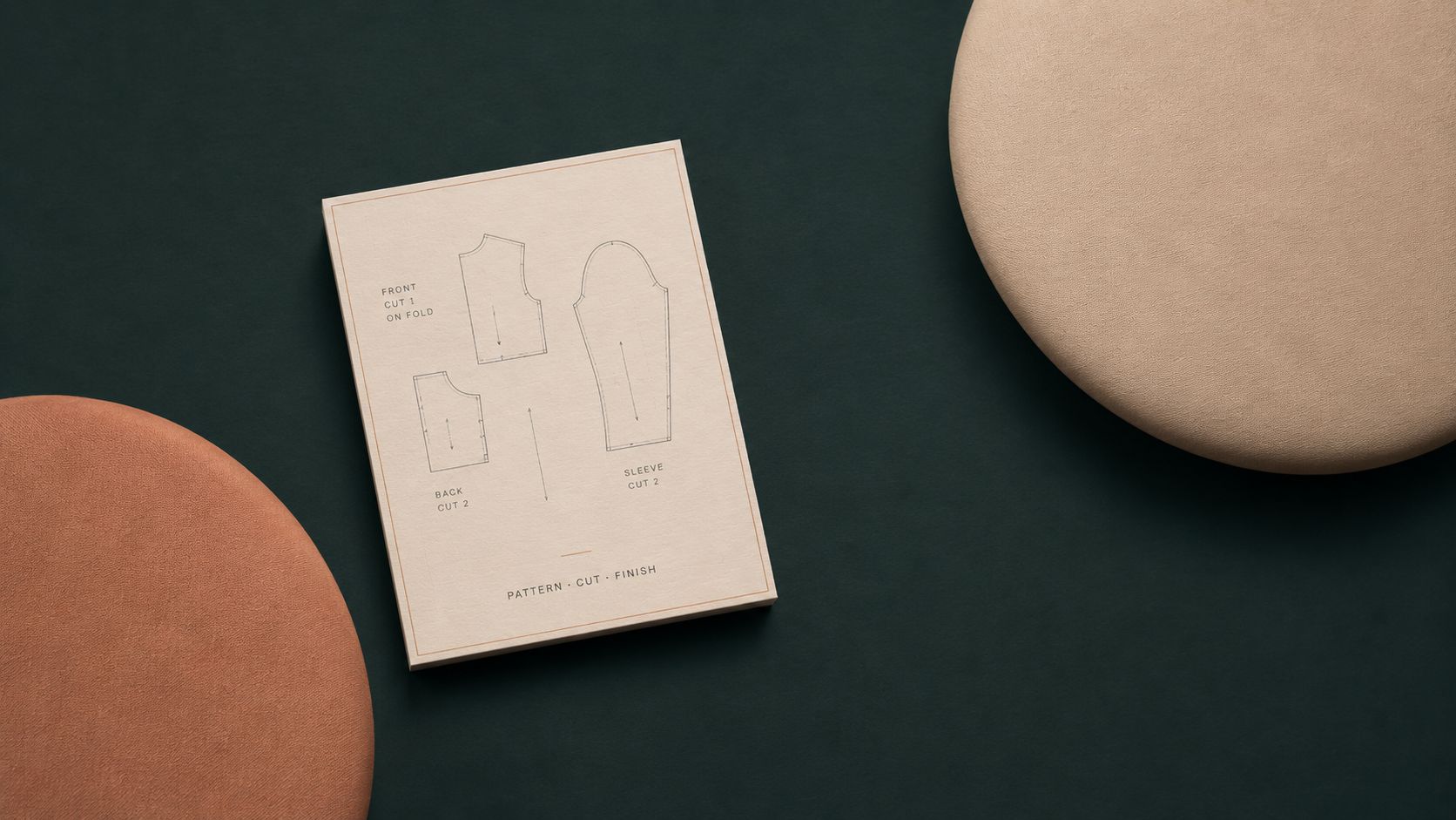 Garment pattern artwork surrounded by refined fabric textures